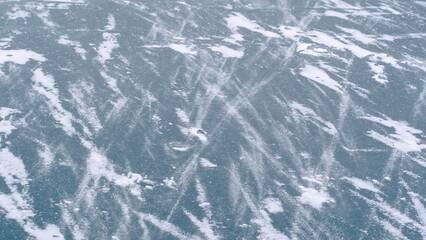Top view flat lay stock photography of real blue ice and white snow texture. Abstract natural snowy icy background. Frozen river water 
