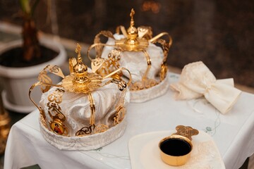 golden crown of white fabric with a pattern lie on a table