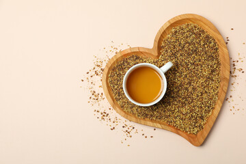 Concept of hot drink with buckwheat tea on light background
