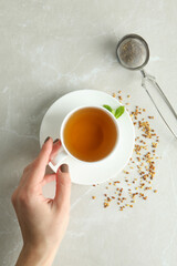 Concept of hot drink with buckwheat tea on light textured table
