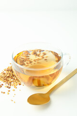 Concept of hot drink with buckwheat tea on white background