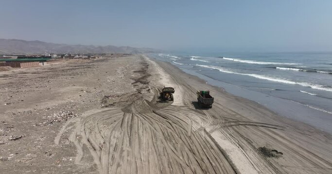 Heavy machinery moves sand contaminated by oil after the oil spill at the La Pampilla refinery, on January 22, 2022 in Ventanilla, Callao