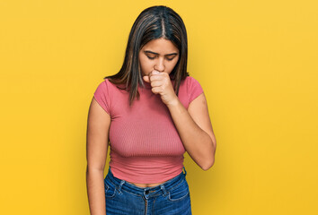 Young hispanic girl wearing casual t shirt feeling unwell and coughing as symptom for cold or...