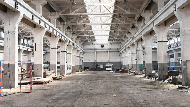 Old and abandoned industrial complex. Interior of former factory. Ruined warehouse hall. Results of failed privatization in socialist countries.