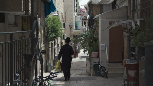 A local resident on the narrow street of Mea Shearim