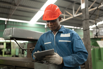 Portrait mechanic man use tablet with machine at factory