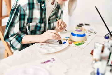 Fototapeta na wymiar Artist student girl painting pottery at art studio.