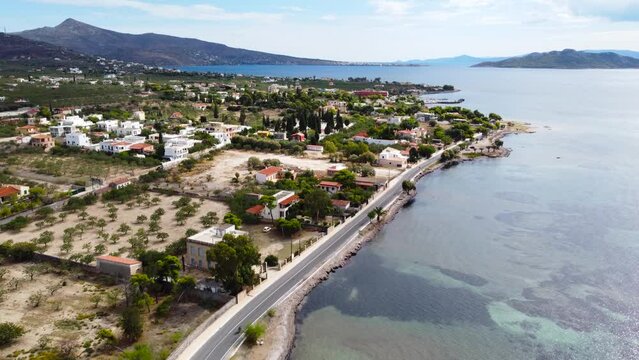 Aerial drone bird's eye view photo of boats docked in paradise island of Moni next to Aigina with emerald crystal clear waters, Saronic gulf, Greece