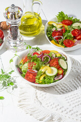 Vegetable salad with cucumber, tomato, sweet pepper in a white plate