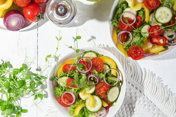 Vegetable salad with cucumber, tomato, sweet pepper in a white plate