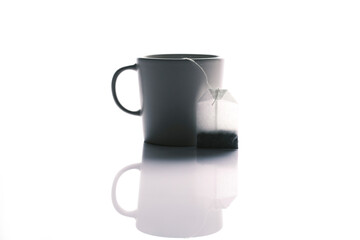tea bag and mug on white background