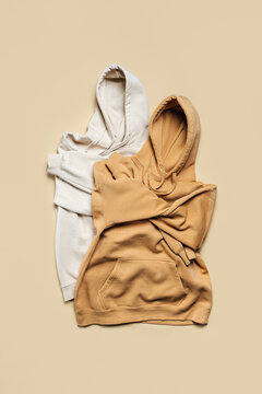 Two Hoodies In White And Beige Colors. Fashion Outfit, Casual Youth Style, Sports. Stylish Autumn Or Spring  Clothes.