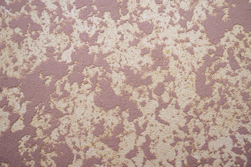 Texture of light-colored plastered wall for background. Texture of a mottled pink-orange concrete wall.