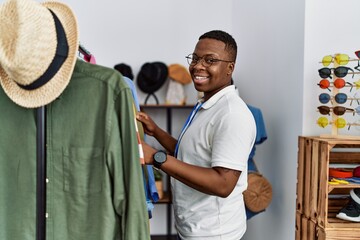 Young african man working as shop assistance at retail shop