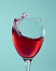 Red wine splashing in a glass