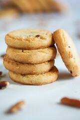 Stack of pecan sandies cookies. Selective focus with blurred foreground and background.