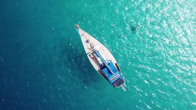 Aerial shot expensive luxury sailing boat moored on the sunny clean in archipelago of guna yala, san Blas - Panama.
