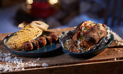 Grilled vegetables and meat balls served on wooden table