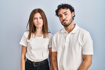 Young couple wearing casual clothes standing together depressed and worry for distress, crying angry and afraid. sad expression.