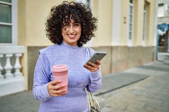 Young middle east woman smiling confident using smartphone at street