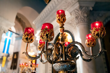 Ornate gold candelabra lamp in the Greek church interior