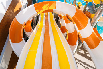 First person view color photography of bright white, yellow and orange colors big water slide