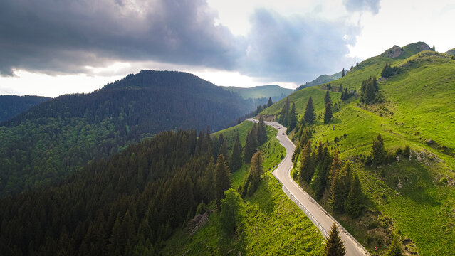 Aerial view of Transbucegi road in Bucegi Mountains from Romania in cloudy summer landscape. Amazing motorways of Romania.