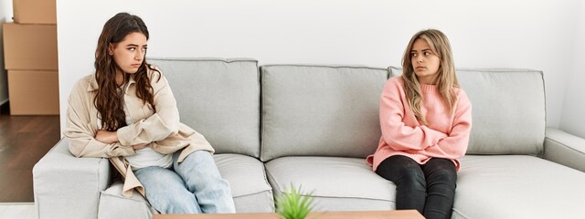 Young couple angry sitting on the sofa in silence at home.