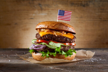 Double burger with American flag skewer and vegetables