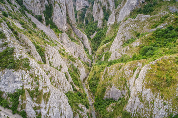 Fototapeta na wymiar Aerial view over Turda Gorges - Cheile Turzii next to Cluj-Napoca in Romania during a summer day. Amazing mountain landscape.