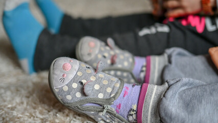 Baby girl's shoe, close-up.  Slippers on baby's feet. Baby feet. Childhood. Footwear.