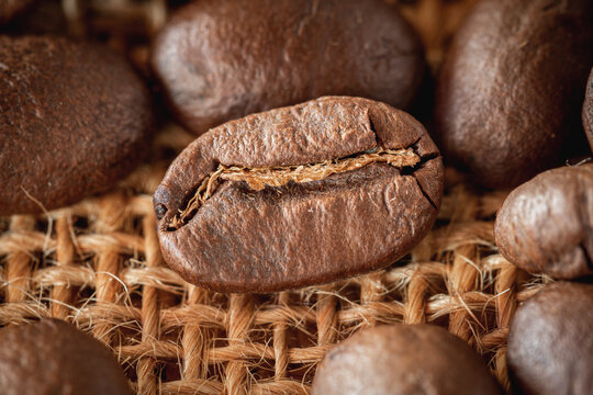 Close up of Roasted Coffee bean on burlap background with selective focus