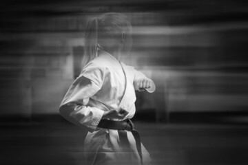 Young sportswoman in karate training. Added blur effect for more motion effect. Retro style with...