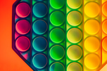 Close up shot of octagon pop it toy on colorful background. Indoors
