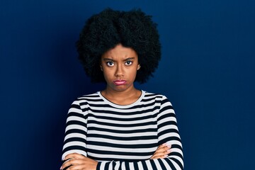 Obraz na płótnie Canvas Young african american woman wearing casual clothes skeptic and nervous, disapproving expression on face with crossed arms. negative person.