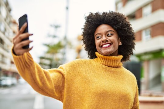 Young african american girl smiling happy making selfie by the smartphone at the city.