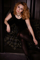 Fototapeta na wymiar Young woman with red hair posing in studio