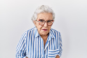 Senior woman with grey hair standing over white background with hand on stomach because indigestion, painful illness feeling unwell. ache concept.
