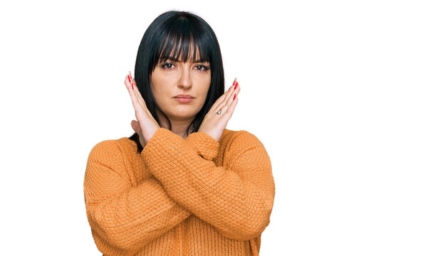 Young hispanic woman wearing casual clothes rejection expression crossing arms doing negative sign, angry face