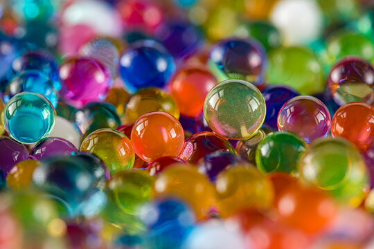 Water beads close-up, abstract background. Texture of Hydrogel balls or many colorful orbeez for wallpaper.