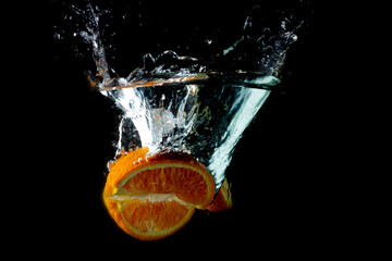Fototapeta premium Colorful orange splashing into water