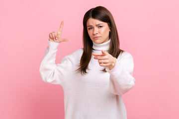Woman expressing disrespect, showing L finger sign to camera, loser gesture, accusing for failure,...