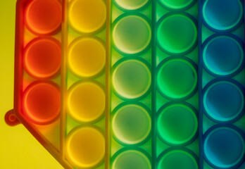 Close up shot of octagon pop it toy on colorful background. Indoors