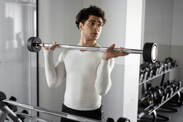 A man healthy lifestyle athlete does cardio workout exercises in the gym. Fitness concept