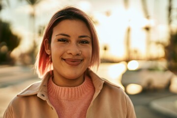 Young hispanic girl smiling happy standing at the city.