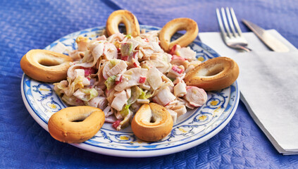  Plate of spanish salad on paper surface