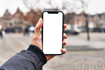  Hand of man holding smartphone at street