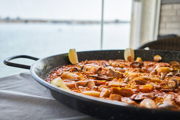  Delicious spanish shellfish paella on cloth surface