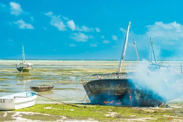 Cercles muraux Plage de Nungwi, Tanzanie Réparation de bateaux de pêcheurs locaux sur une plage à marée basse à Nungwi Zanzibar, Tanzanie
