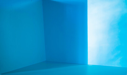 Blurred image of Light and shadow in the backdrop of an open blue color inside the room